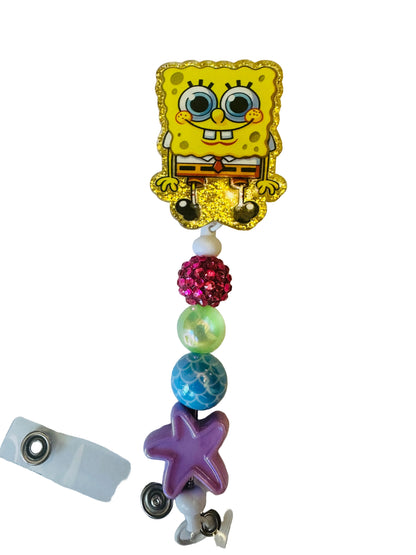 Colorful badge holder with a cartoon character and beads on a white background