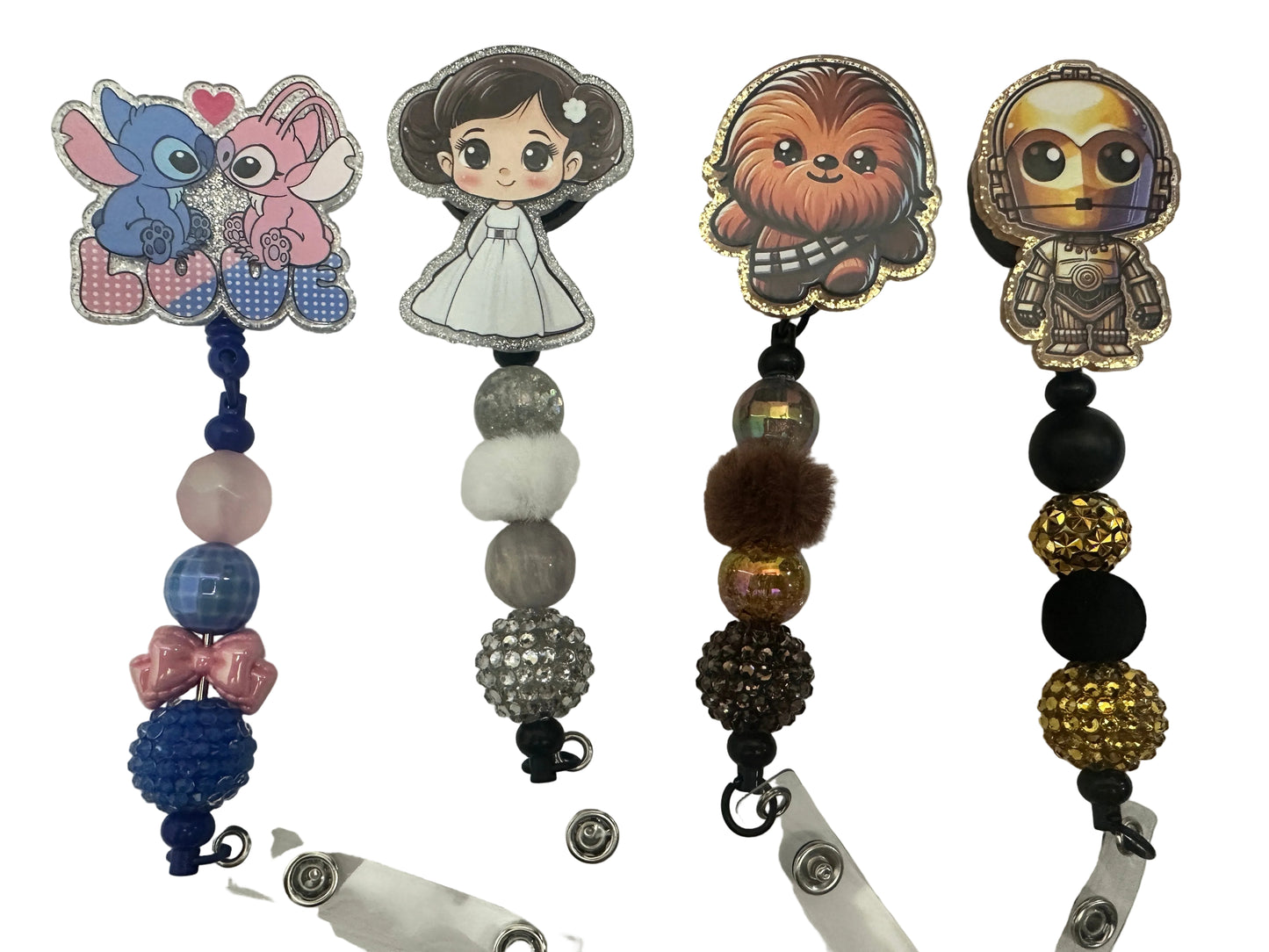 Collection of character-themed badge holders with beads on a white background
