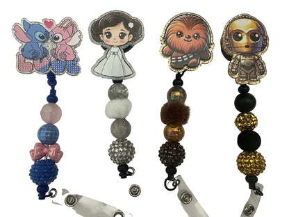 Collection of character-themed badge holders with beads on a white background