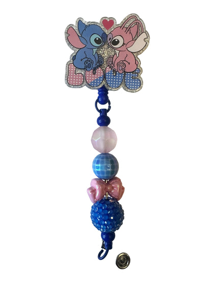 Decorative keychain with cartoon character and beads on a light background