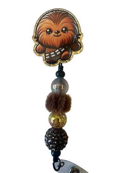 Decorative keychain with a bear face charm and beads on a light background