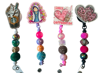 Colorful beaded keychains with decorative charms on a light background